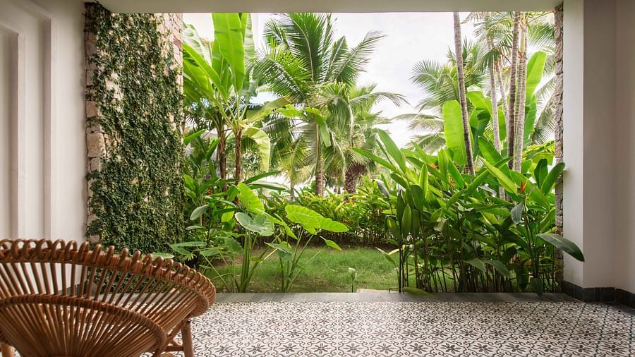 An image of a chair on a room which has an outdoor view - Alibu Resort Nha Thrang