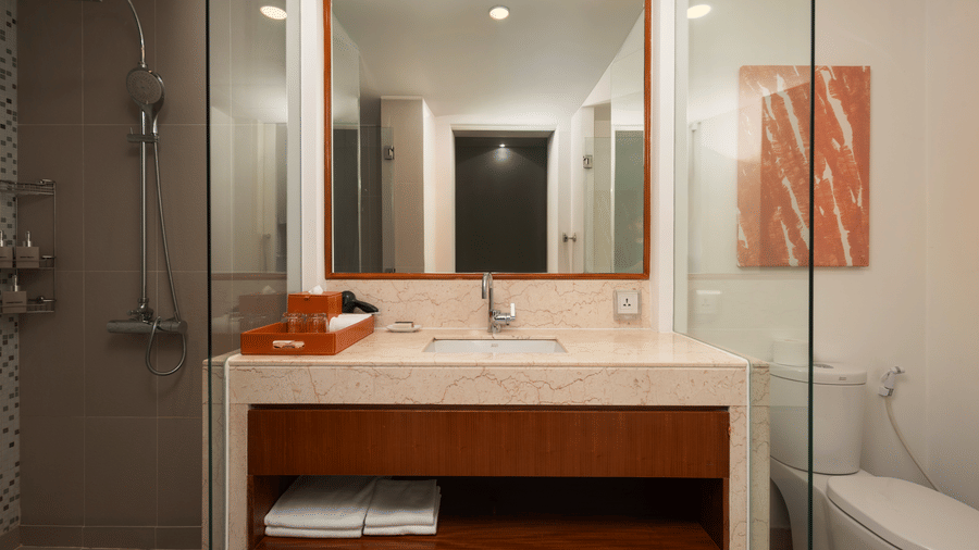 Penthouse bathroom at Central Mansions, Phnom Penh with a walk in shower, vanity, bathtub, and modern fixtures.