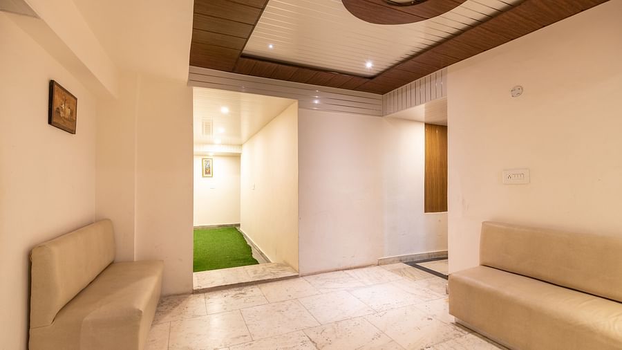 Image of a lobby at the hotel with two creme coloured couch | DLS Anupam Resort, Dharamshala