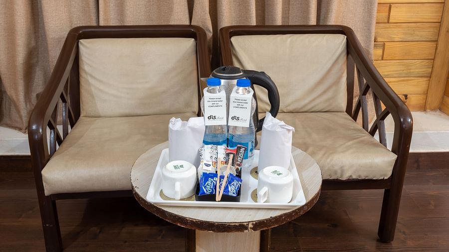Image of two chairs with tea and coffee essentials kept on the table | DLS Anupam Resort, Dharamshala