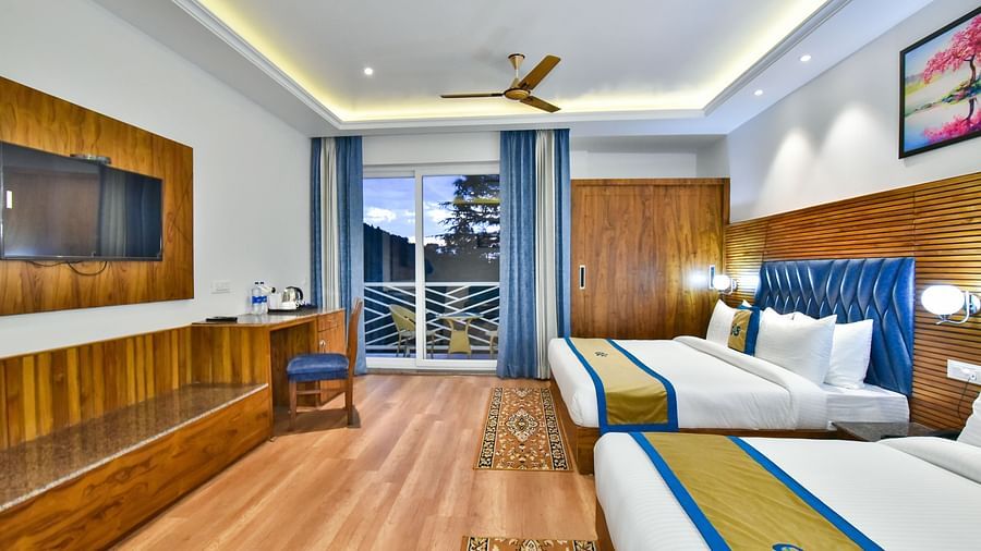A view through the sofa of a two large beds in Family Suite Room at DLS Ark Holiday Inn, Banikhet.
