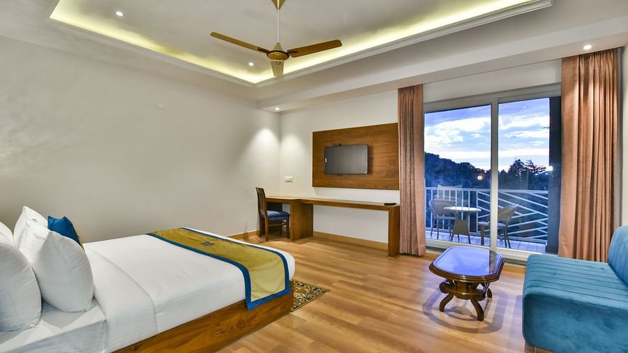 A view of the TV placed in front of the TV in Premium Room With Balcony at DLS Ark Holiday Inn, Banikhet.