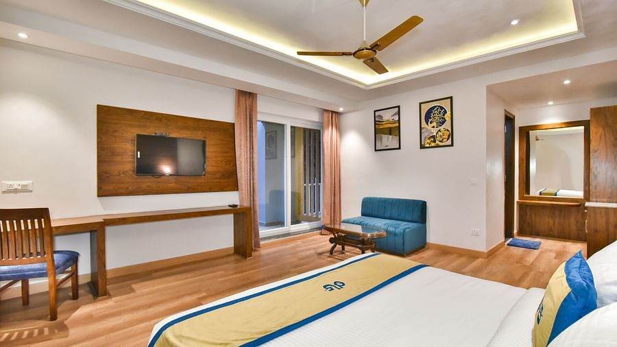 A view of the TV placed in front of the TV in Premium Room With Balcony at DLS Ark Holiday Inn, Banikhet.