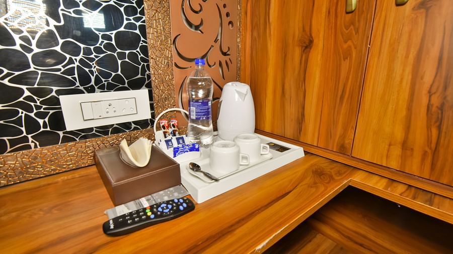 Super Deluxe room at DLS Dalhousie Valley Resort featuring room amenities like tea and coffee maker.