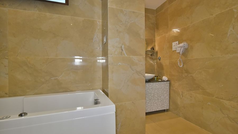 Luxury Room Washroom at DLS Dalhousie Valley Resort featuring a Jacuzzi and sink area.