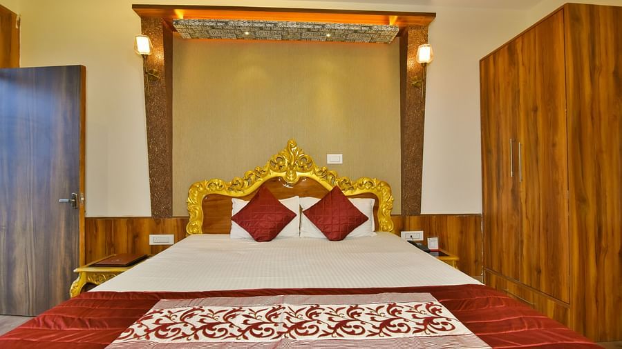 A Luxury Room at DLS Dalhousie  Valley Resort with a premium bed and wardrobe. .