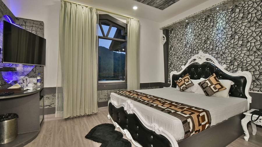 A Luxury Room at DLS Dalhousie  Valley Resort with a premium bed and balcony