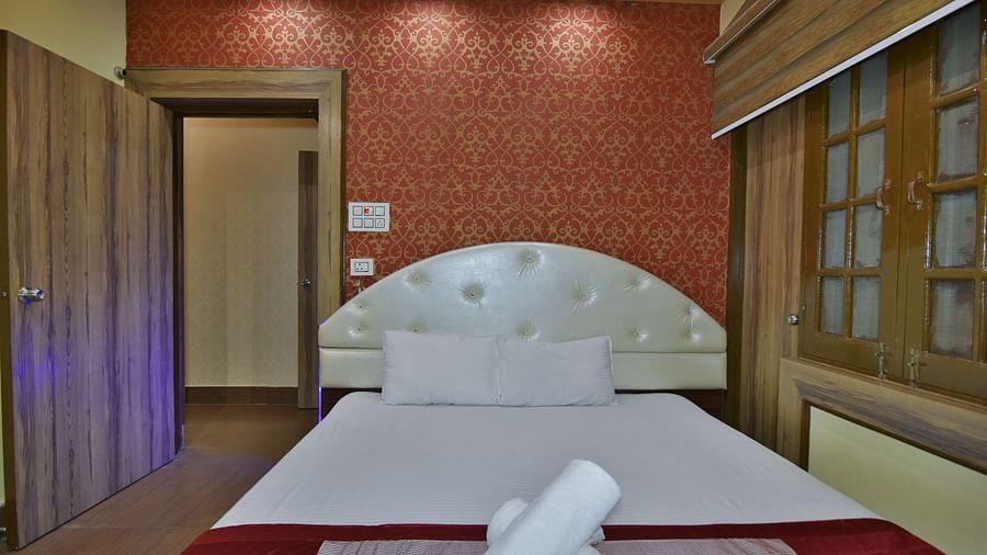 Family Suite at DLS Dalhousie Valley Resort with a king size bed, towels and a door. 