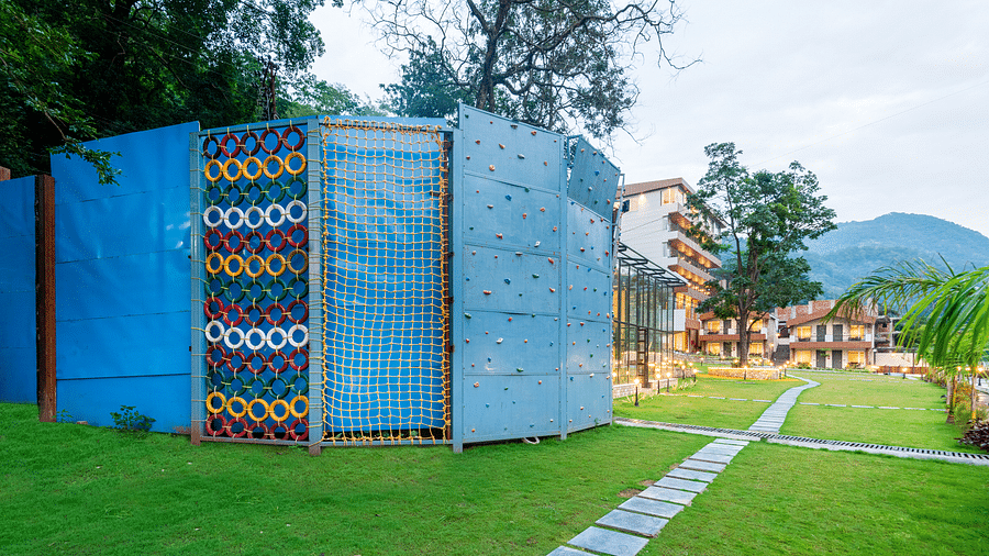 Adventure activities area in the garden of DLS Divine River Resort and Spa with rock climbing structure