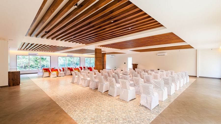 Overview of banquet hall at DLS Divine River Resort and Spa featuring  chairs table arranged in classroom setting and a stage