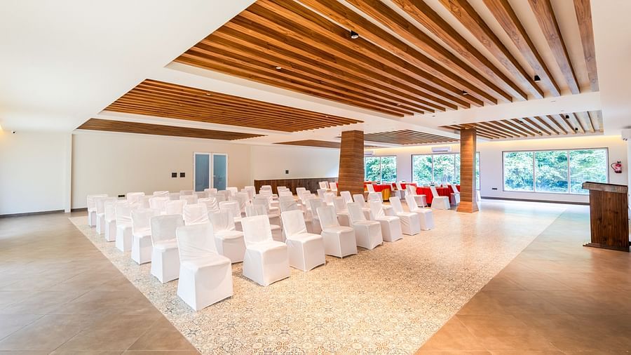 Banquet Hall at DLS Divine River Resort and Spa featuring  chairs table arranged in theater setting and a stage