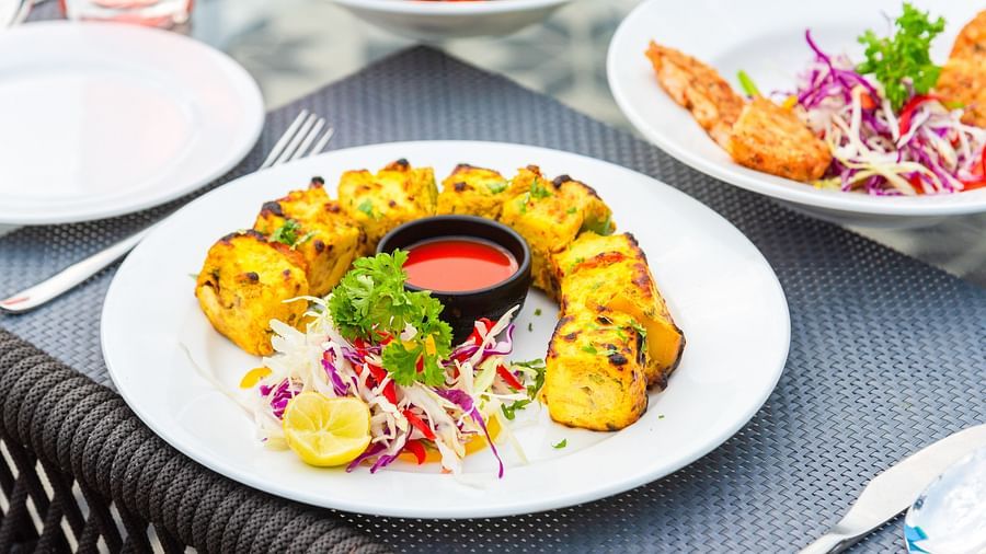 Paneer Tikka plated and kept on the table of a restaurant at DLS Divine River Resort and Spa 