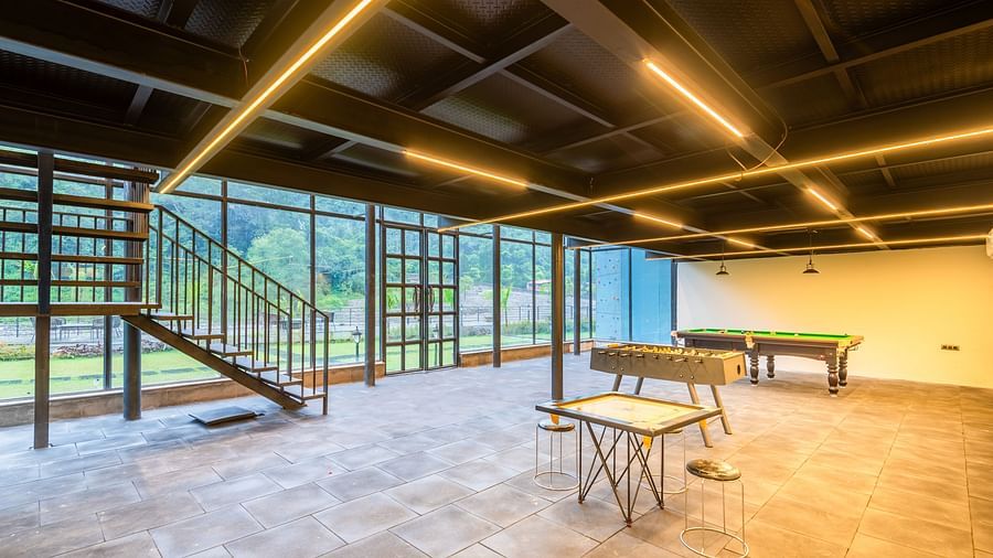Indoor gaming area at DLS Divine River Resort and Spa featuring  various game tables.