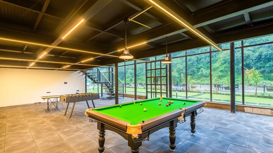 Indoor gaming area at DLS Divine River Resort and Spa featuring a pool table..