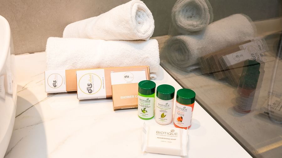 Bathroom of Deluxe Room at DLS Divine River Resort and  Spa featuring towels and shampoos.