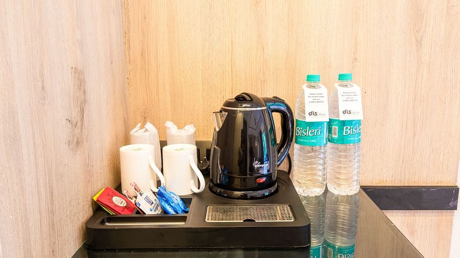 Premium Room at DLS Divine River Resort and Spa featuring tea and coffee maker kept on a table.