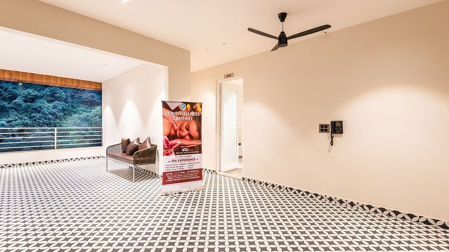 Entrance of Spa at DLS Divine River Resort and Spa with black and white floors and a banner.