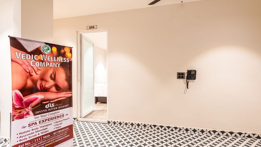 Close up view of entrance of Spa at DLS Divine River Resort and Spa with black and white floors and a banner.