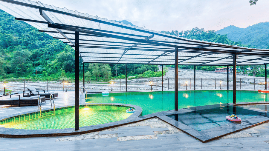 A swimming pool at DLS Divine Resort and Spa , Rishikesh, with serene views and kids pool area.