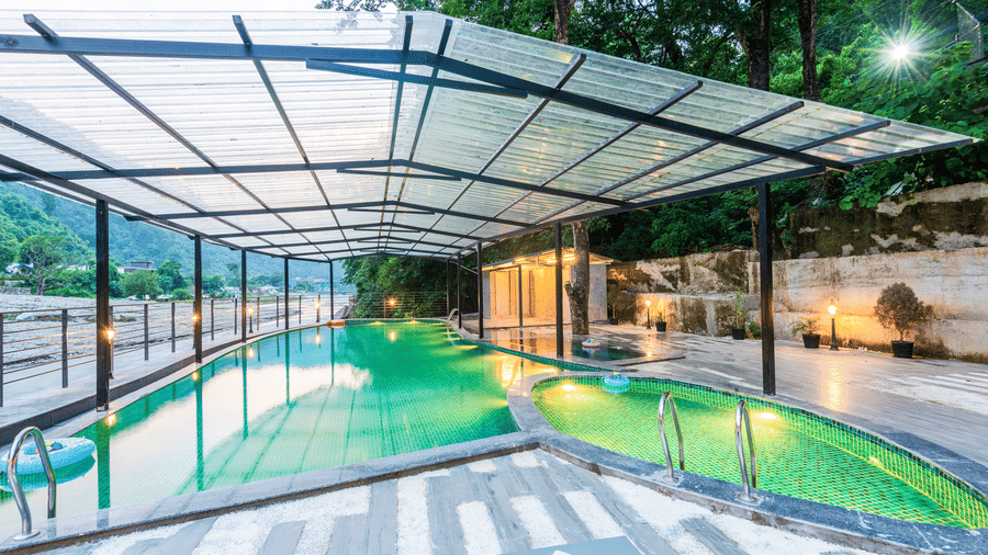 A swimming pool at DLS Divine Resort and Spa, Rishikesh, with serene views and kids pool area.