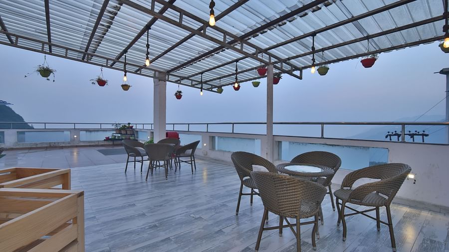 A view of the cafe with comfortable seating area at the rooftop at DLS Highland Resort and Spa, Mussoorie.