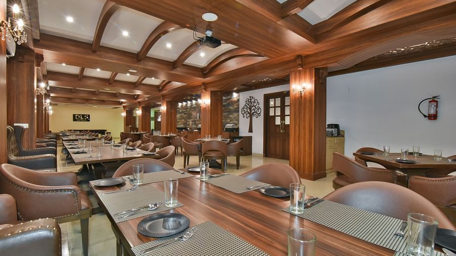 Dining seating with comfortable chairs around table at Ruttba at DLS Highland Resort and Spa, Mussoorie.