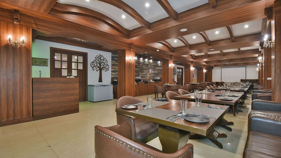 Dining seating with comfortable chairs around table at Ruttba at DLS Highland Resort and Spa, Mussoorie.