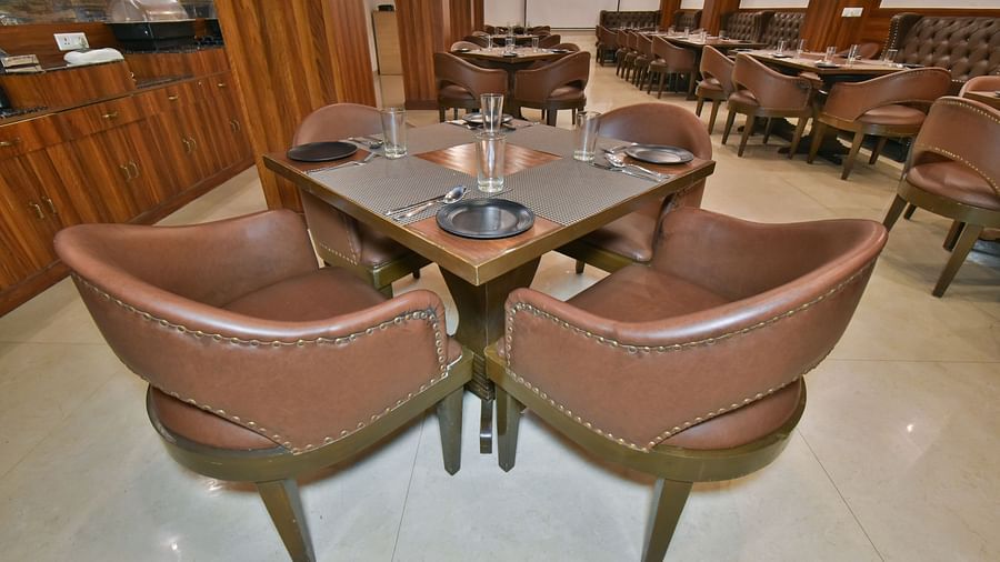 Dining seating with comfortable chairs around table at Ruttba at DLS Highland Resort and Spa, Mussoorie.