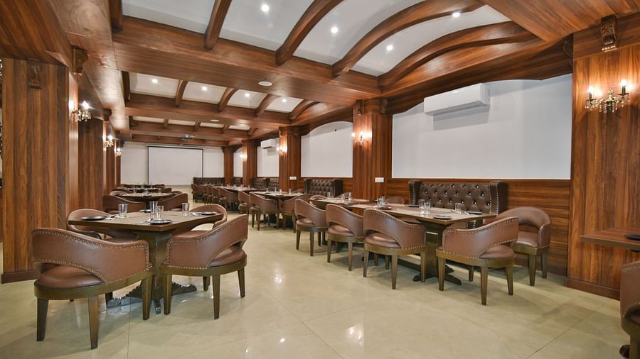 Dining seating with comfortable chairs around table at Ruttba at DLS Highland Resort and Spa, Mussoorie.