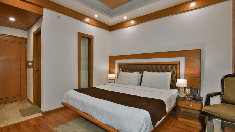 A large bed in Luxury Room Without Balcony at DLS Highland Resort and Spa, Mussoorie, with elegant flooring and modern interiors.