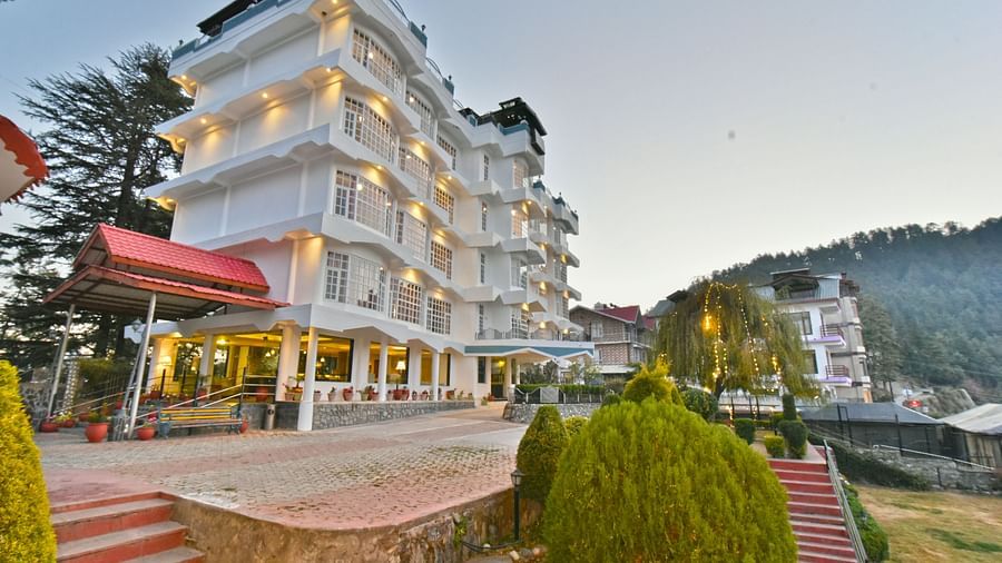 Side view of the facade showcasing the architecture and scenic surroundings of DLS Hillcrest Resort, Shimla.