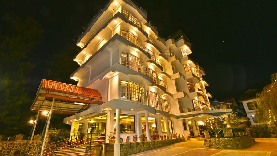 Exterior view of the  DLS Hillcrest Resort, Shimla illuminated with warm lights.