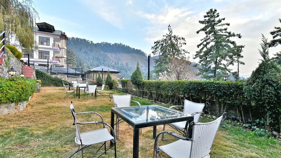 Lawn with chairs offering garden views at DLS Hillcrest Resort, Shimla.