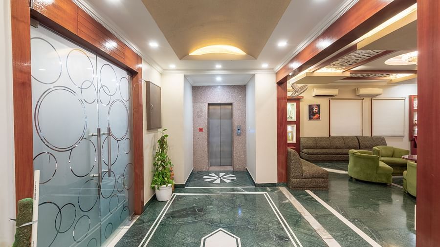 Elevator area at DLS Park Grace, Haridwar featuring the lift, seating area, and bright lighting.
