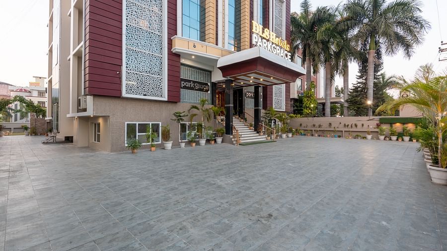 Exterior of DLS Park Grace, Haridwar featuring a huge concrete lawn and there are also several trees within the property. 