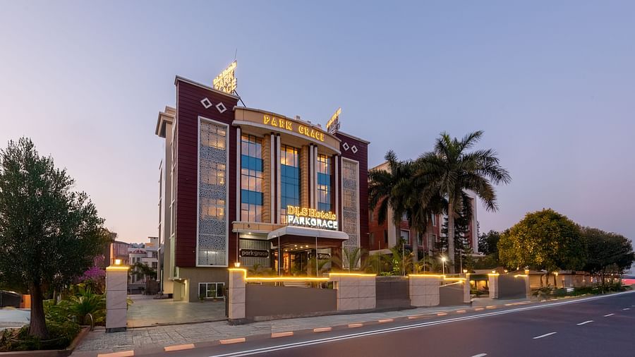 Exterior of DLS Park Grace, Haridwar featuring well infrastructure, warm lighting, main road and the green surroundings.