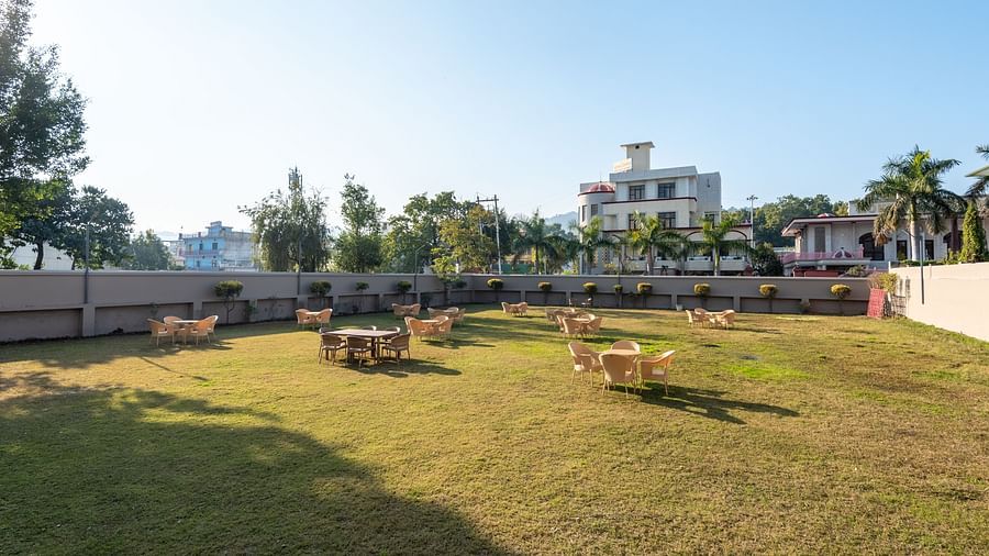 Spacious lawn area with seating arrangements at DLS Park Grace, Haridwar.