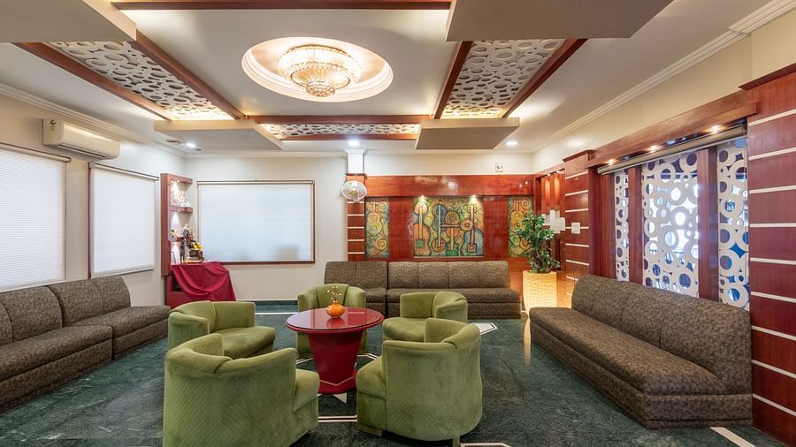 Lobby area with cushion sofas and a fancy ceiling at DLS Park Grace, Haridwar.