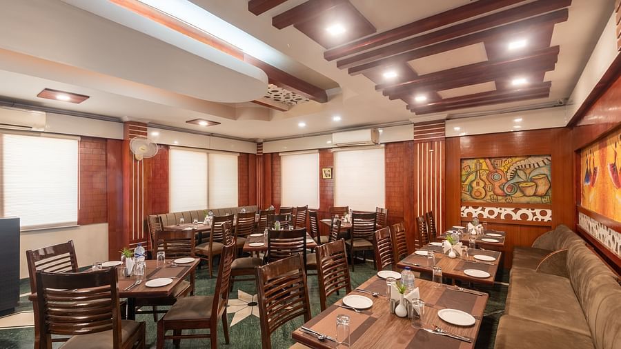 Dining area with fancy ceiling lights at DLS Park Grace, Haridwar.