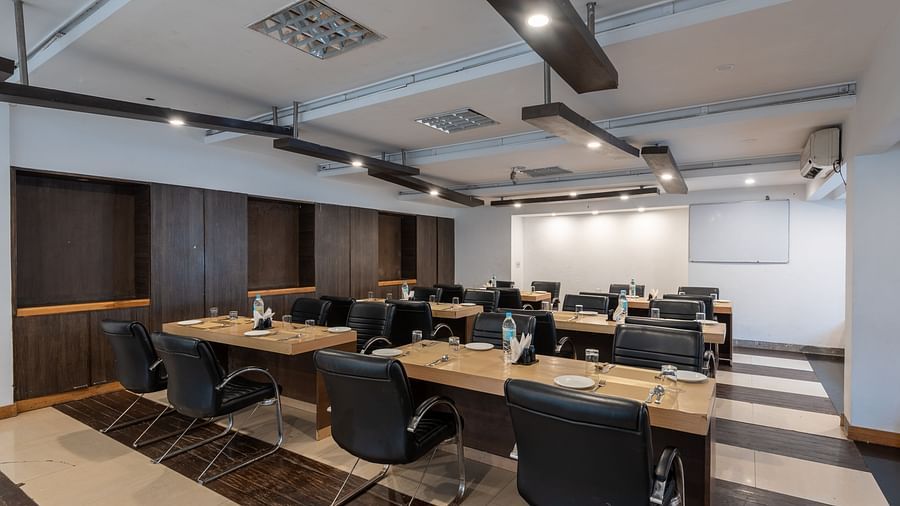 Conference Hall  at DLS Spring Valley Resort Dharamshala  with chairs and tables arranged in classroom setting 