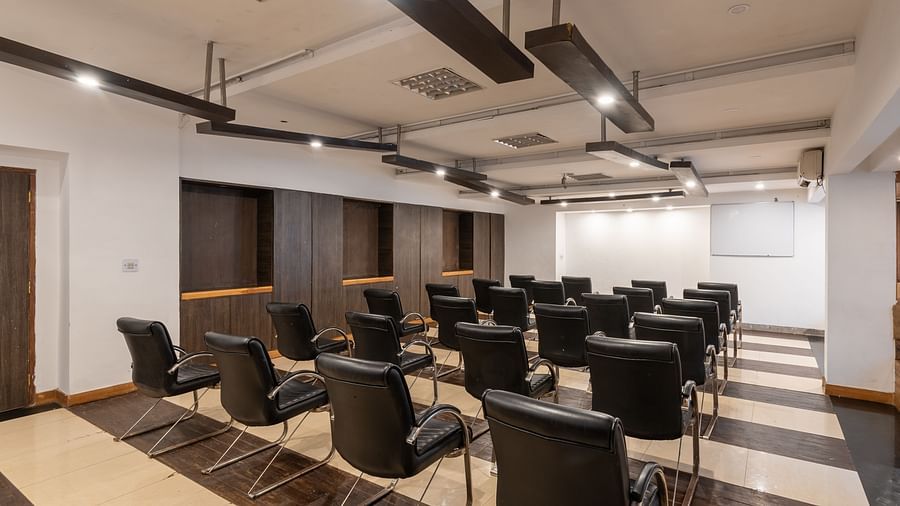Conference Hall  at DLS Spring Valley Resort Dharamshala  with chairs and tables arranged in theater setting 