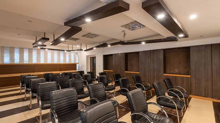 Conference Hall  at DLS Spring Valley Resort Dharamshala  with chairs and tables arranged in theater setting 