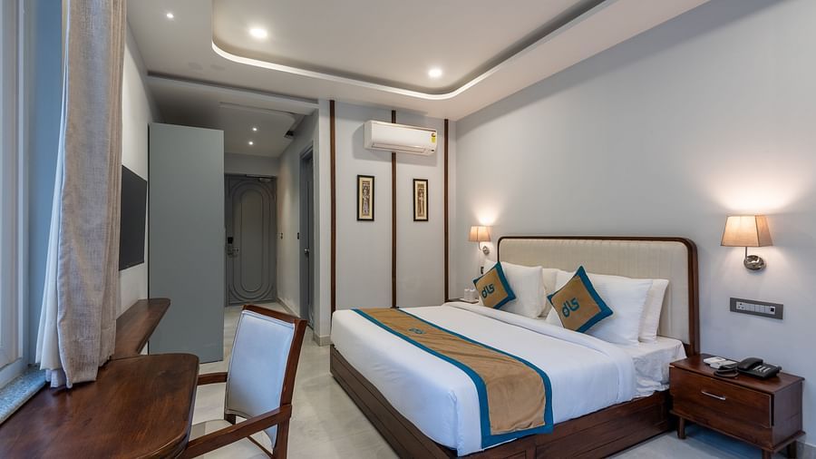 Overview of Spring Suite at DLS Spring Valley Resort Dharamshala featuring a kind bed, work desk and chair and ambient lighting
