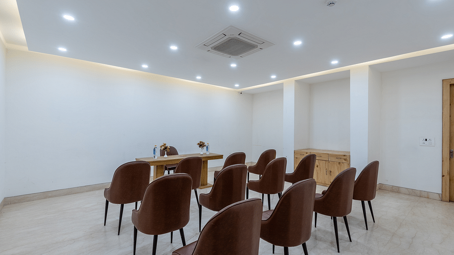 Conference room with multiple chairs and an air-conditioner, set up for a meeting or presentation at DLS The Classio