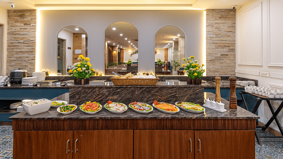 A variety of fresh salads displayed on a restaurant table at DLS The Classio