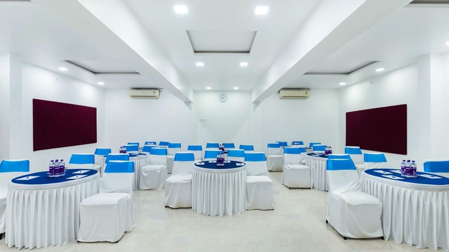 Elegant white and blue cluster seating arrangement setup for events at Emerald Retreat, Tungarli.