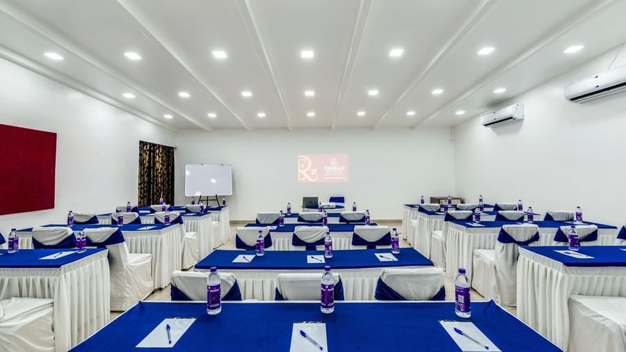 Classroom seating arrangement with long rectangular table setup and blue accents at Emerald Retreat, Tungarli.