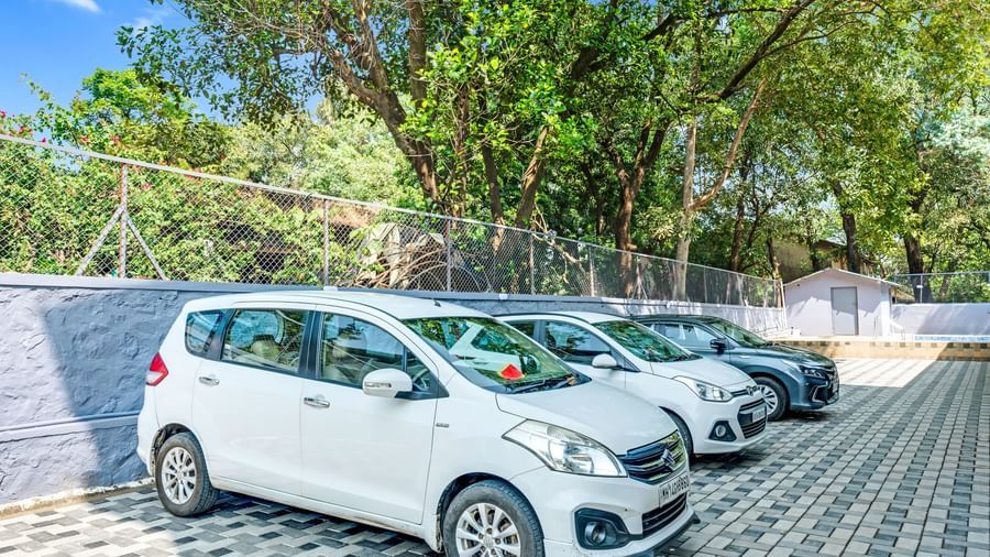 Ample on-site car parking facility with multiple cars at Emerald Retreat, Tungarli.