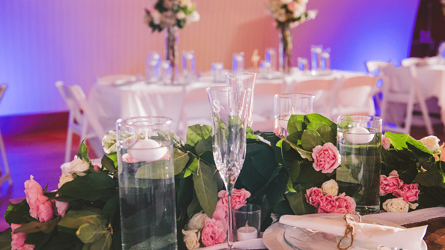 close up image of a table with fresh tulips kept along a champagne glass and white porcelain plates - Historic Tapoco Lodge