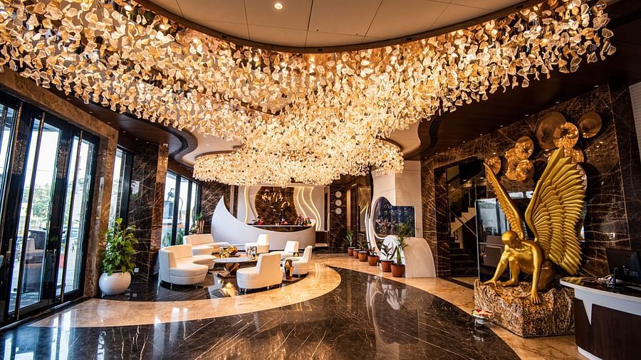 lobby of Hotel Park Elanza, Coimbatore decked with bright lights and plush seating arrangements